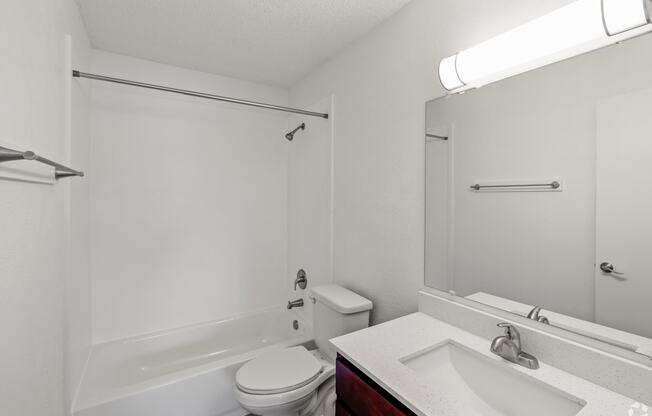 a bathroom with a sink toilet and a bath tub