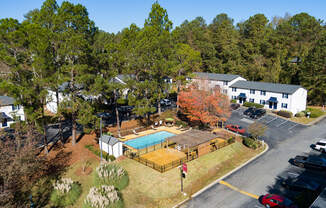 an aerial view of a property with a swimming pool and tennis court