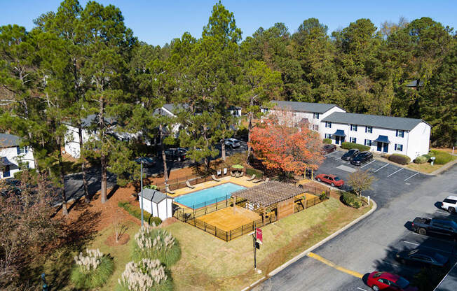 an aerial view of a property with a swimming pool and tennis court