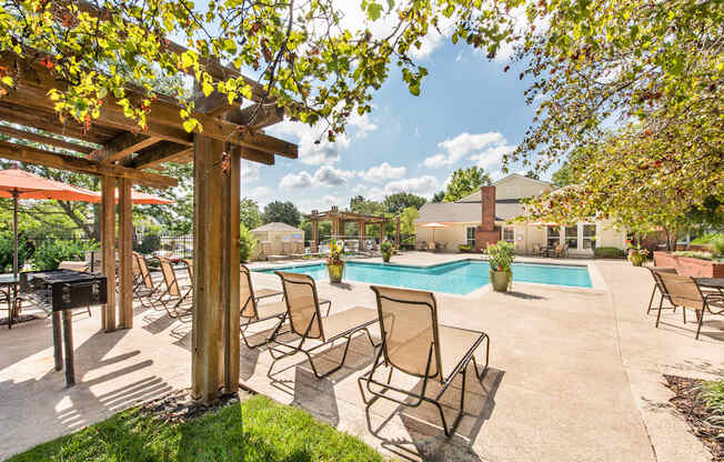 our apartments have a resort style pool with chairs and tables at Highland Ridge Apartments, Overland Park , KS