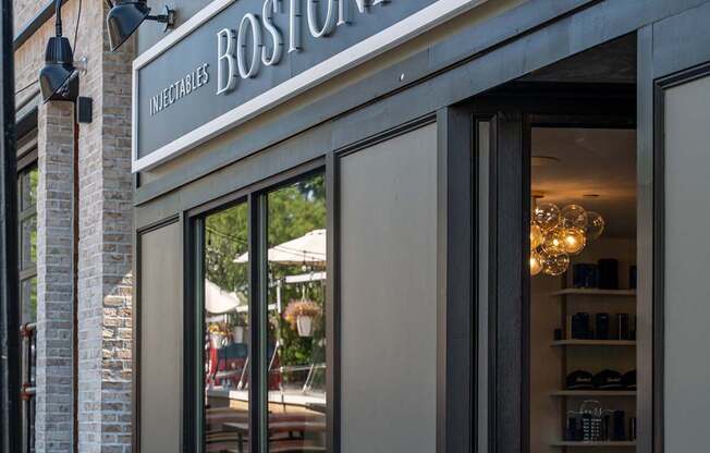 The Boston Hydration storefront is shown with a clear glass door and a sign above it.