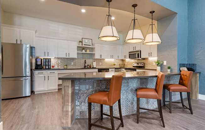a kitchen with a large island with three chairs at Summerwind, Pearland, TX 77584