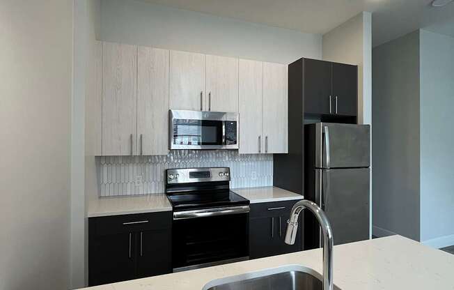 A modern kitchen with a sink and cabinets.