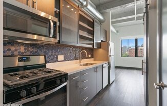 a kitchen with a stove and a sink and a microwave