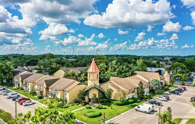 an aerial view of a neighborhood with houses and a church