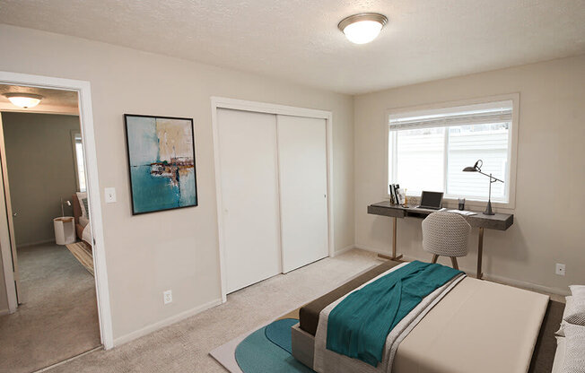 a bedroom with a bed and a desk