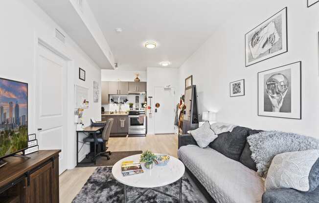 A living room with a grey couch and a coffee table.