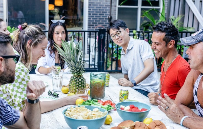 a group of people sitting around a table eating food
