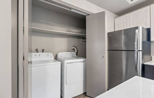 A white washing machine and dryer in a kitchen.