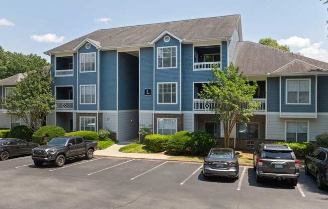 an apartment building with cars parked in front of it