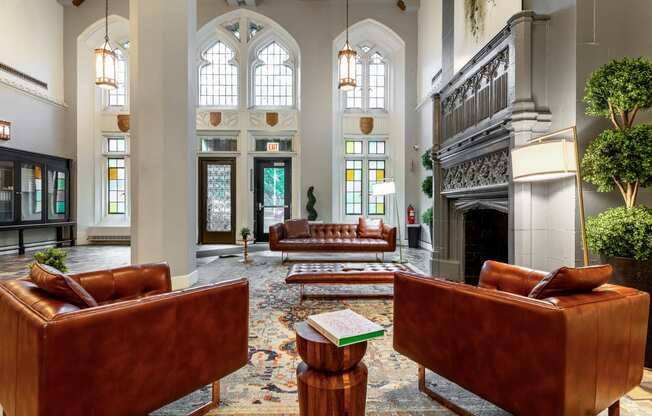 a large lobby with leather furniture and a fireplace