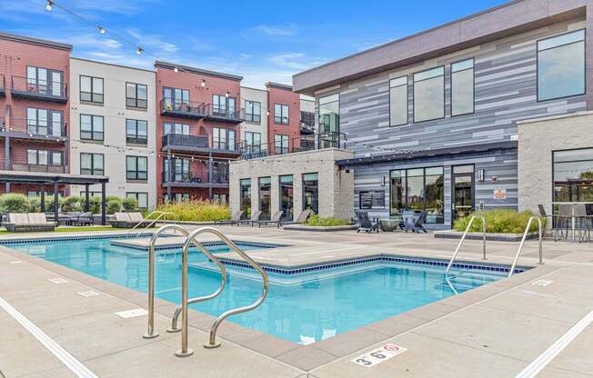 A swimming pool surrounded by apartment buildings.