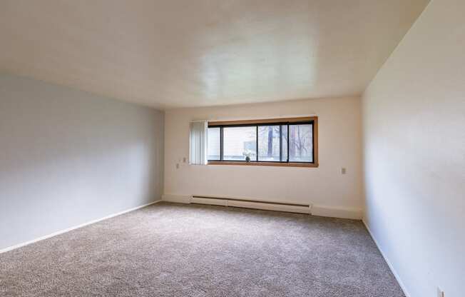 an empty room with a window in it. Fargo, ND Spring Apartments