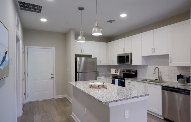 a kitchen with granite counter tops and stainless steel appliances