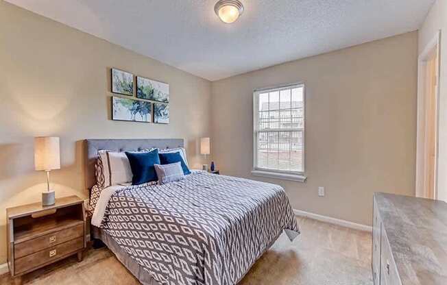 A bedroom with a large bed and a window.