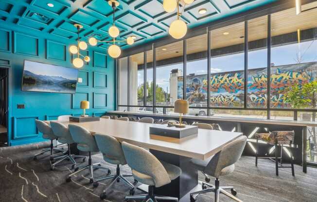 a conference room with blue walls and a large table and chairs