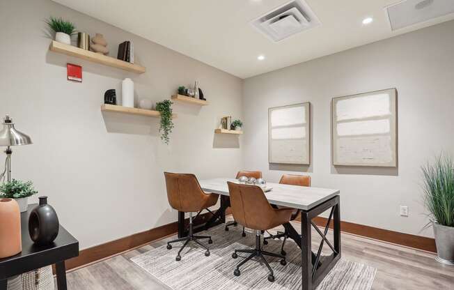 a conference room with a white table and chairs and two windows