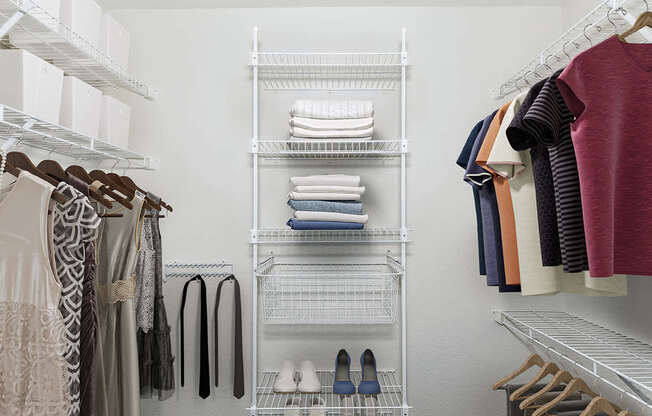 a walk in closet with wardrobe organizers at Black Sand Apartment Homes in Lincoln, NE
