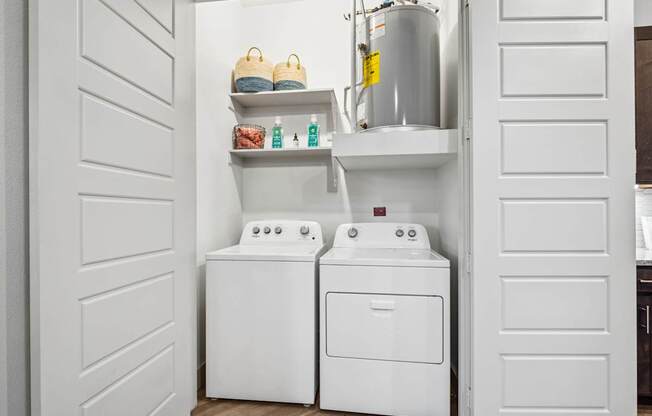 A white laundry room with a washer and dryer.