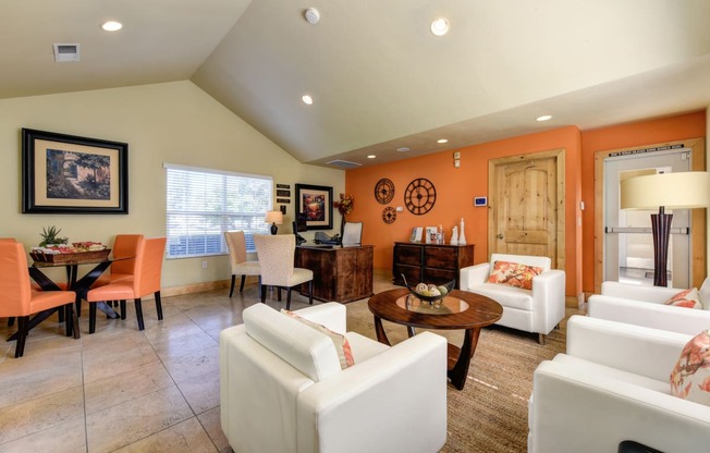 Vineyard terrace leasing office with lounge area and orange accent wall. 