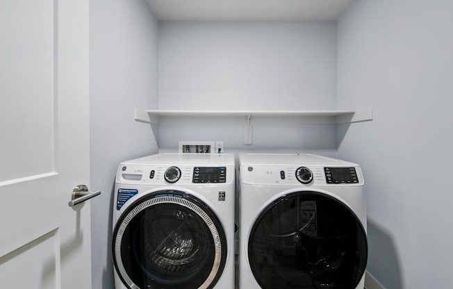 Two front load washing machines in a laundry room.