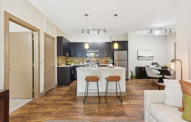 a view of a living room and kitchen with an open floor plan  at Lakeline East Apartments, Cedar Park, TX, 78613
