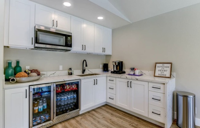 a kitchen with white cabinets and white countertops