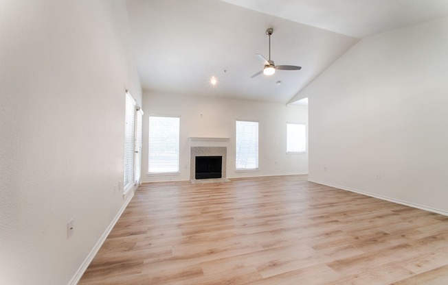 a living room with hardwood floors and white walls