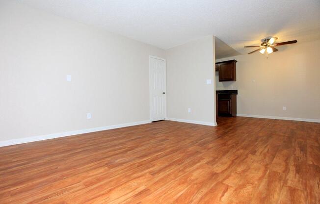 a large empty room with a wood floor