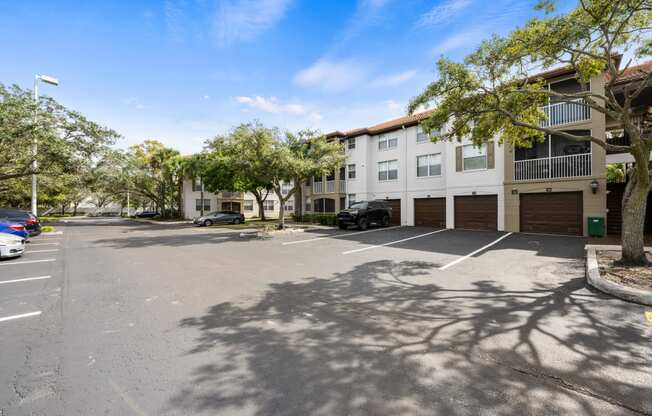 an empty parking lot in front of an apartment building