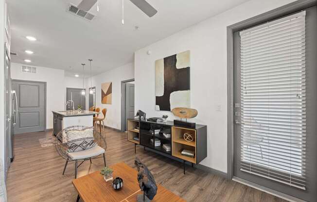 A modern living room with a wooden floor and a ceiling fan.