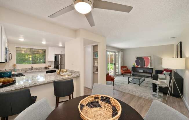 Dining Area with Kitchen, Ceiling Fan/Light, Black Table and Granite Countertop