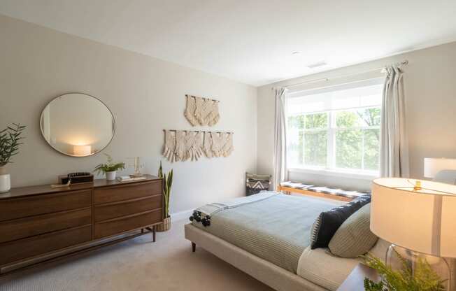 a bedroom with a bed, dresser,  and a window at Edgebrook Residences, New Hampshire