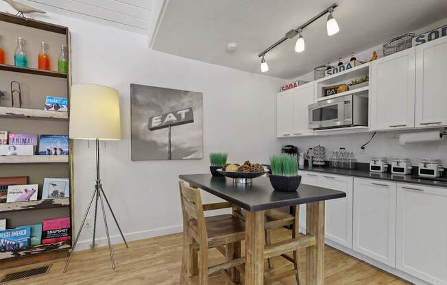 A kitchen with a table and chairs in the middle of it.