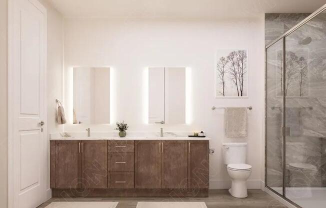 Primary bathroom with a double vanity, illuminated mirrors, wood-tone cabinetry, and a glass-enclosed shower designed for daily ease.