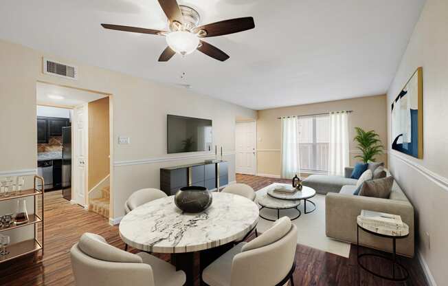 a living room with a ceiling fan and a large window