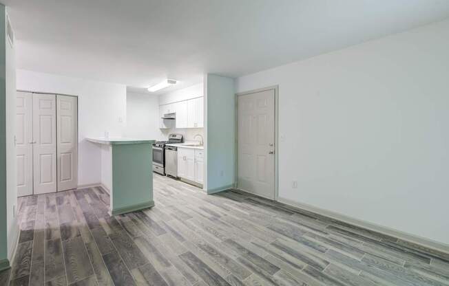 A renovated kitchen and living room with luxury vinyl floors at Laurel Oaks in Raleigh, NC