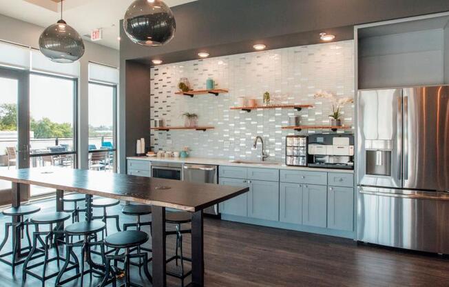 a kitchen with a bar and a stainless steel refrigerator at Barrington 101, Barrington, IL