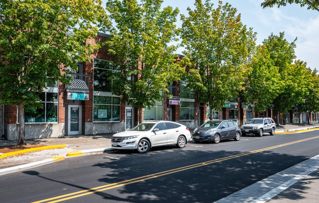 a city street with cars parked in front of buildings