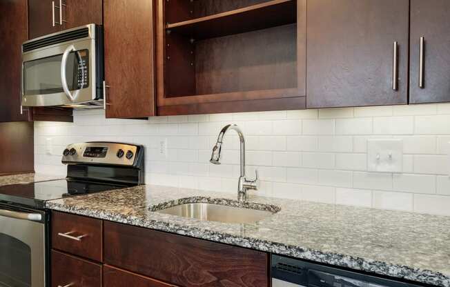 12 South Apartments - Nashville TN - kitchen with dark wood cabinets and stainless steel appliances