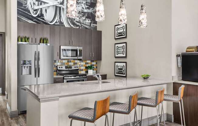A modern kitchen with a large island and bar stools.