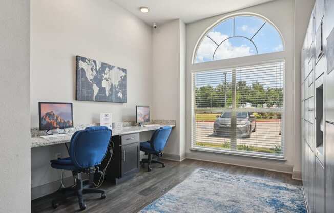 a office with a large window and a desk with two chairs
