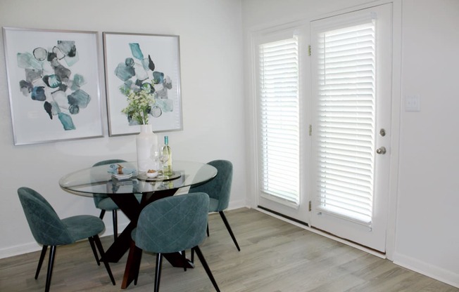 hardwood-style floor in dining area with double doors leading to deck  at Huntsville Landing Apartments, Huntsville, 35806