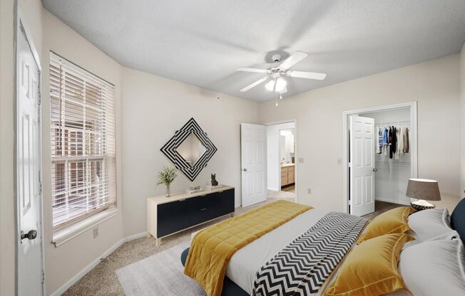 A bedroom with a bed, dresser, and mirror.
