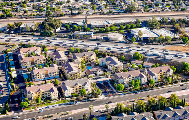 an aerial view of a suburb of a city with an intersection and parking lot