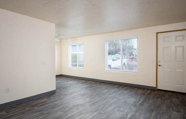 A room with a white door and a window with blinds.
