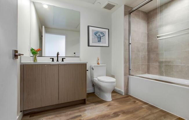 a bathroom with a toilet sink and shower