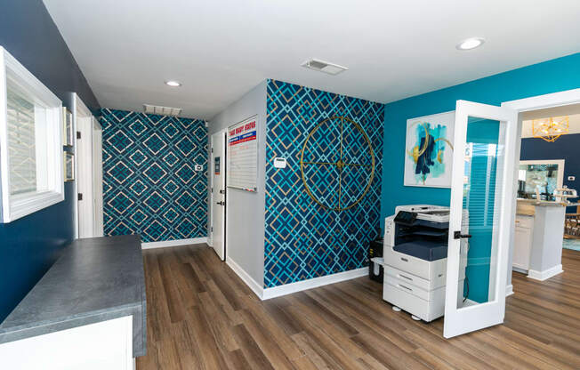 a dentist office with blue and white walls and wood floors