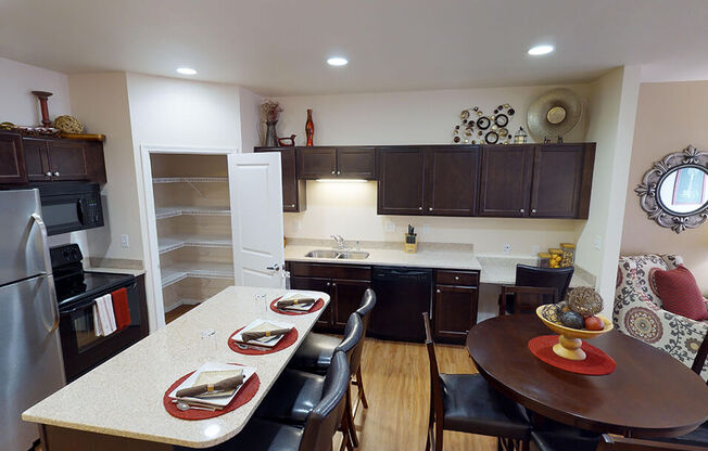 a kitchen with a table and chairs