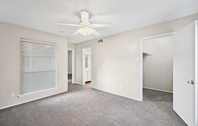 a bedroom with a ceiling fan and closet
